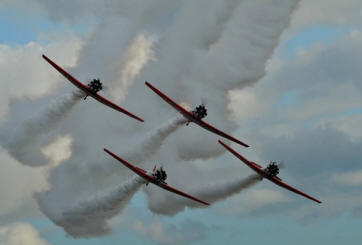 T-6 Texan aircraft of the Aeroshell  AT-6  Acrobatic Team perform over Witham Field for the 2012 Stuart Air Show on Saturday.